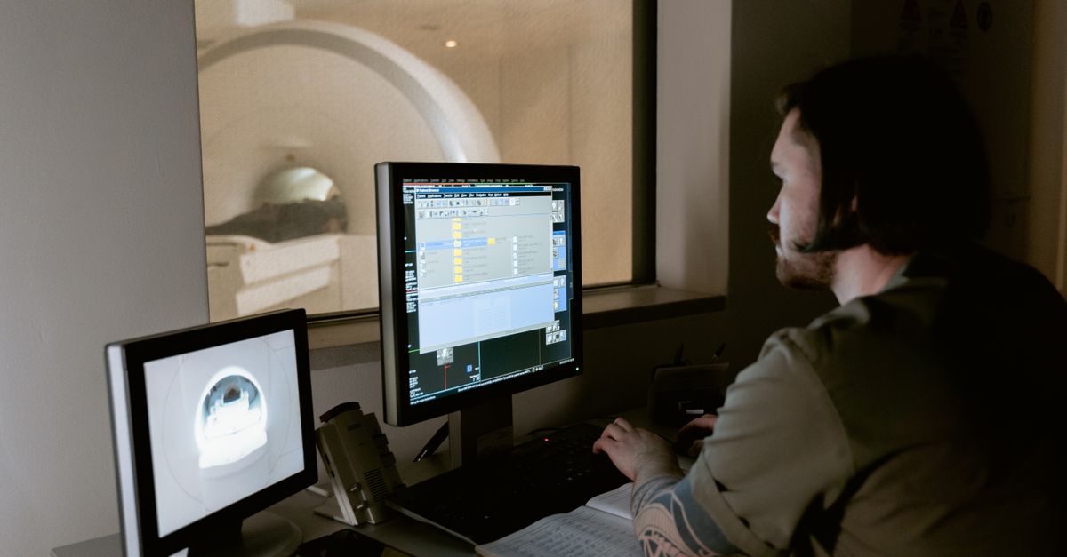 Healthcare professional reviewing clinical information at a workstation